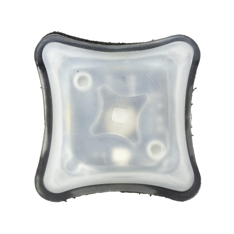Black Unity Tactical Spark IR marker light with a matte finish and Velcro backer, shown against a dark background.
