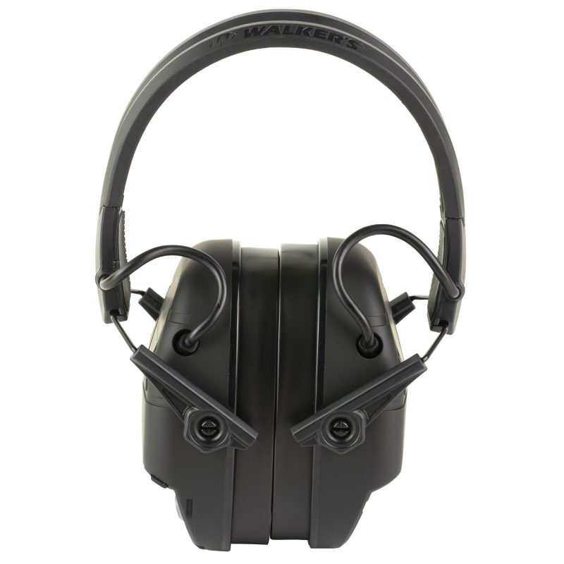 Black Walker's Firemax Bluetooth Electronic Earmuffs with a USB-C charging cable, shown ready for use on a ranch.