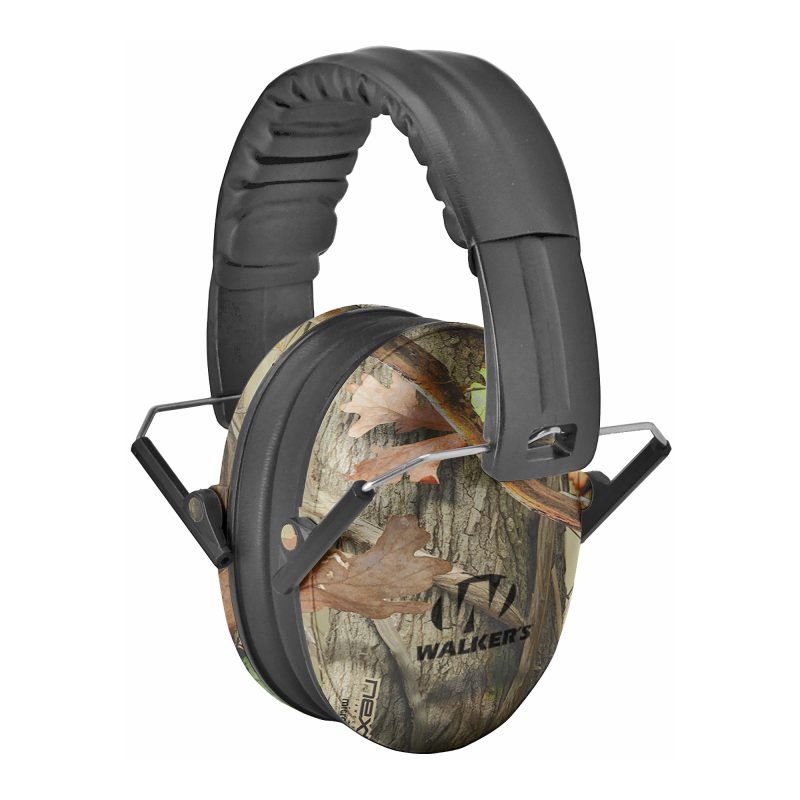 Walker's compact passive ear muffs in camouflage, designed for smaller heads, shown against a rugged outdoor background, ready for use.