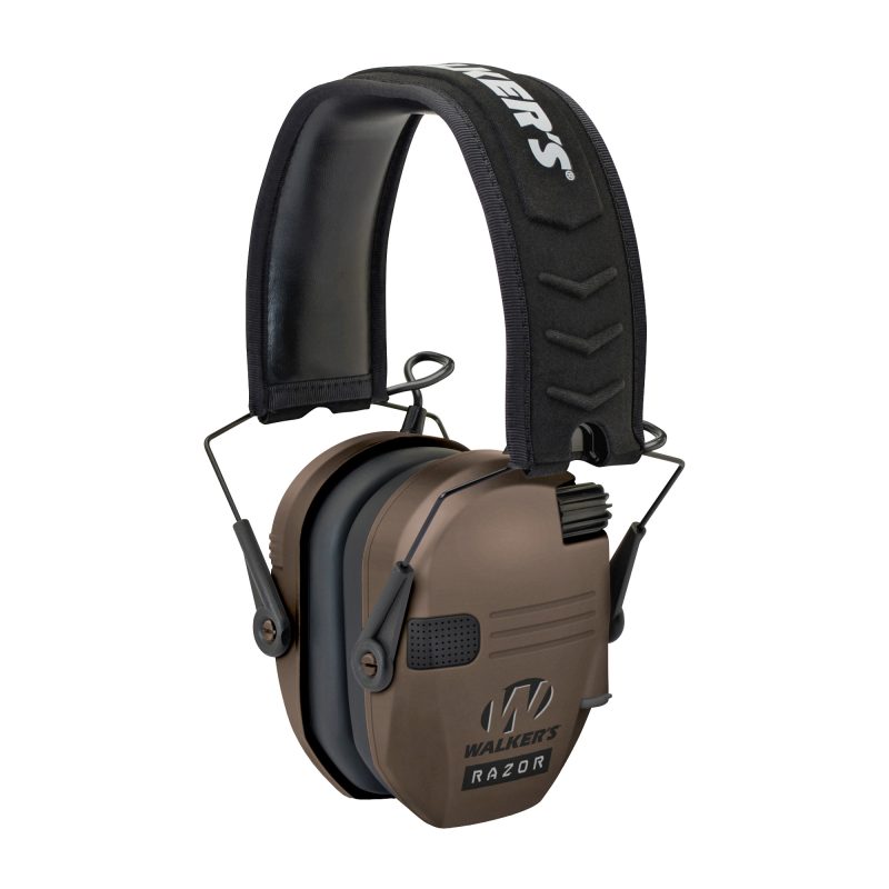 A pair of Walker's Razor Slim Electronic Earmuffs in flat dark earth color, shown ready for use in a rugged outdoor setting.