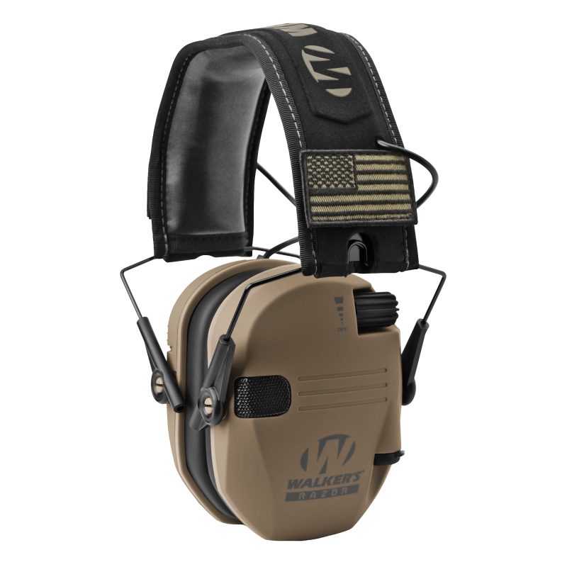 Pair of Walker's Razor Slim Electronic Earmuffs in Flat Dark Earth color, shown with included morale patches, against a rugged outdoor background.