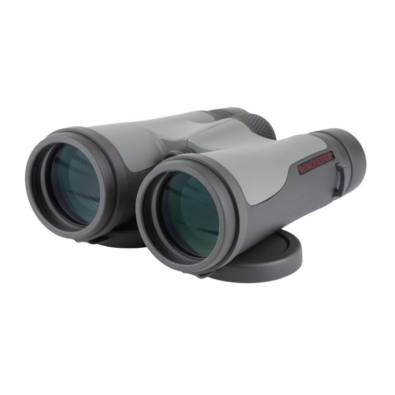 Winchester Supreme Optics 10X50mm Binocular in black and gray, shown with included lens covers, cleaning cloth, chest harness, and padded case.