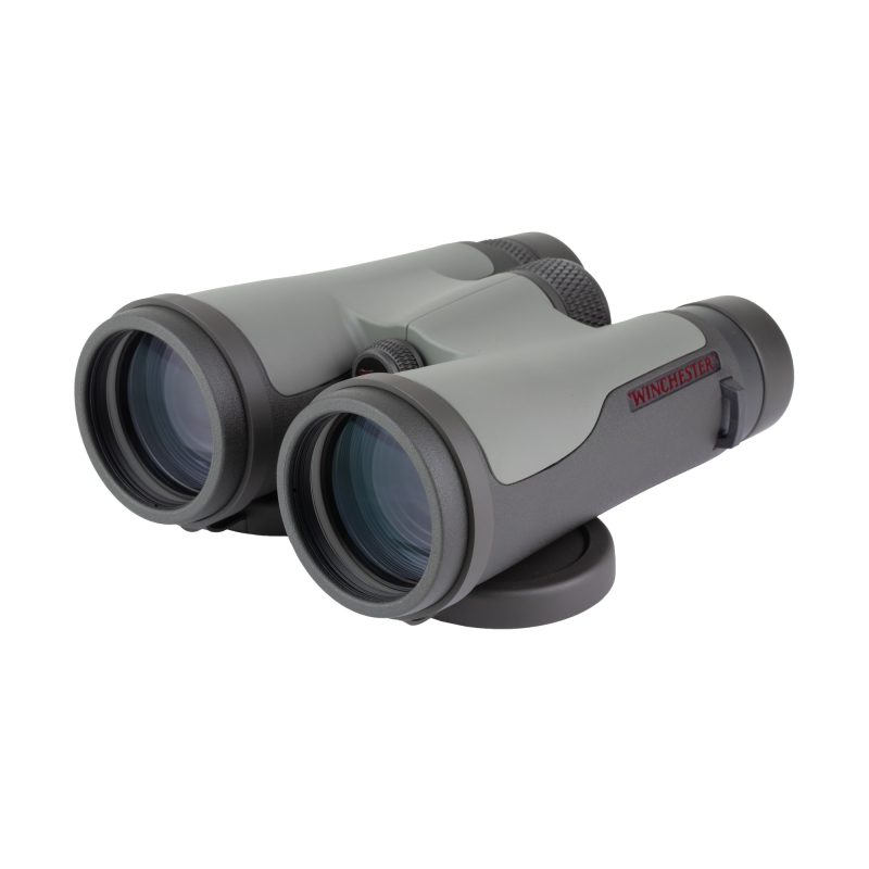 Winchester Supreme Optics 12X50mm Binocular in black and gray, with lens covers, cleaning cloth, chest harness, and padded case.